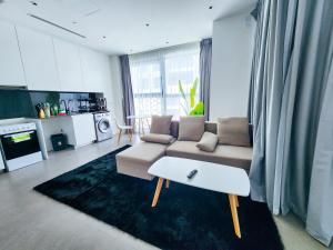 a living room with a couch and a coffee table at Harf3502 Luxurious Large Studio in Abu Dhabi