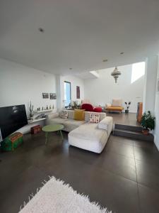 a living room with a couch and a table at Villa Santorini in Torre de Benagalbón