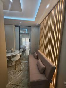a living room with a couch and a table at AGORA luxury APARTMENT 10 in Loutraki