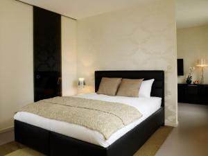 a bedroom with a large bed with white sheets at VISIONAPARTMENTS Waffenplatzstrasse - self check-in in Zurich