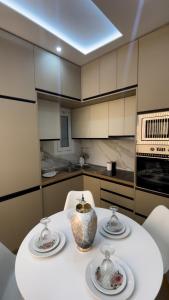 a kitchen with a table with two vases on it at AGORA luxury APARTMENT 10 in Loutraki