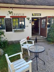 two chairs and a table in front of a restaurant at Wiikki Majatalo in Viitasaari +6 photos