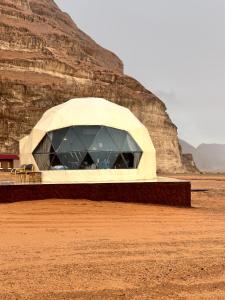 a building in the middle of a desert at Wadi Rum Relaxation Camp in Wadi Rum