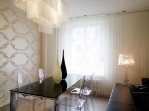 a dining room with a glass table and chairs at VISIONAPARTMENTS Waffenplatzstrasse - self check-in in Zurich