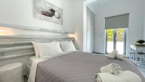 Vuode tai vuoteita majoituspaikassa Hermoso Luxury Suites