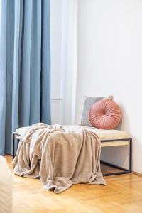 a bed with a blanket on the floor next to a window at Super Central Cozy Home on the St. Stephen Road in Budapest