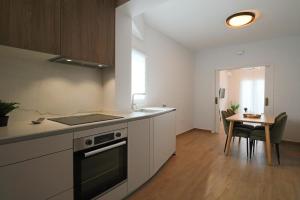 uma cozinha com um fogão e uma mesa em Apartamento Estrella Sol em Cartaya