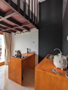 a kitchen with a wooden counter and a sink at Cottage Linggayoni Dieng 1 in Dieng