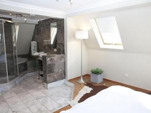 a bedroom with a bed and a bathroom with a shower at VISIONAPARTMENTS Waffenplatzstrasse - self check-in in Zurich