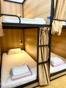 a room with two bunk beds in a boat at A.MING Backpacker & Tours Điện Biên in Dien Bien Phu