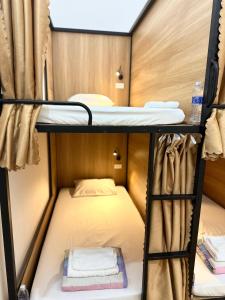 a small room with two bunk beds in it at A.MING Backpacker & Tours Điện Biên in Dien Bien Phu