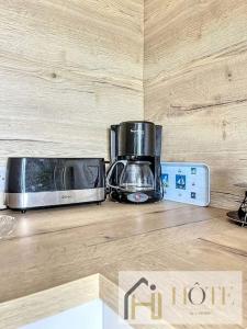 two toasters sitting on top of a kitchen counter at Digue de Mer - Appt Vue Mer, 2 Chambres in Bray-Dunes +13 photos
