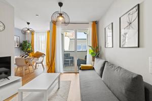 a living room with a couch and a table at Long Term Stay - Near Klinik Floridsdorf - On-Site Parking for 19,90 Eur in Vienna