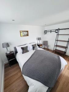 a bedroom with a large bed and a ladder at The West Wing in Devizes