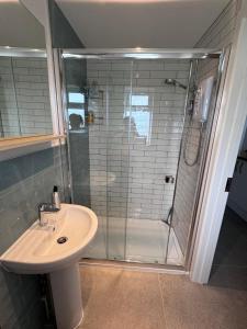 a bathroom with a shower and a sink at The West Wing in Devizes