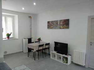 a living room with a table and a television at CASA TURRI in Como