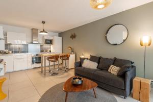a living room with a couch and a table at L'Interprète 405 4 - Apartment with terrace in Annecy