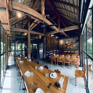 a large dining room with wooden tables and chairs at Ngeeb bed and EV station in Chiang Rai +45 photos