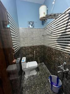 a bathroom with a toilet and a sink at PANMOZHI RESIDENCY in Tiruvannāmalai