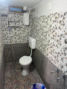 a bathroom with a toilet and a sink at PANMOZHI RESIDENCY in Tiruvannāmalai