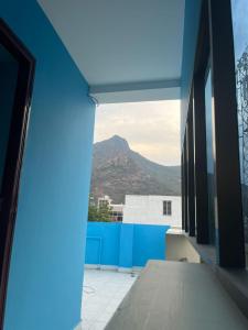 a view of a mountain from a window of a building at PANMOZHI RESIDENCY in Tiruvannāmalai