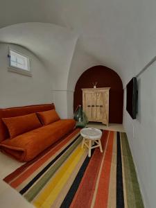 a living room with a couch and a table at La Dimora dei Mille in Ostuni
