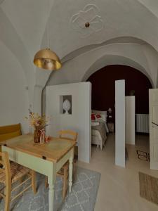 a living room with a table and a bed at La Dimora dei Mille in Ostuni