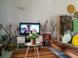 a living room with a tv and a table at Cozy home@Friendship Garden 3 in Kota Kinabalu