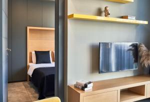 a bedroom with a bed and a tv on a wall at Loft 1502 in Antalya +68 photos