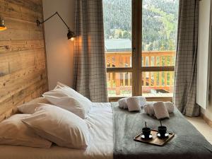 sypialnia z łóżkiem z ręcznikami i oknem w obiekcie Chalet Méribel, 6 pièces, 12 personnes - FR-1-180-194 w Méribel