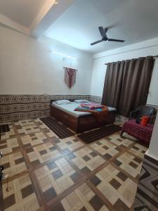 a bedroom with a bed and a ceiling fan at Parbati Headquarters in Kasol +33 photos