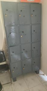 a gray cabinet with many doors in a room at UK YATHRINIVAS in Udupi +15 photos