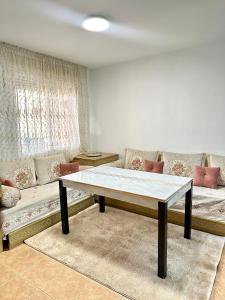 a living room with a table and a couch at Casa rural con jardín y piscina in Val de Santo Domingo