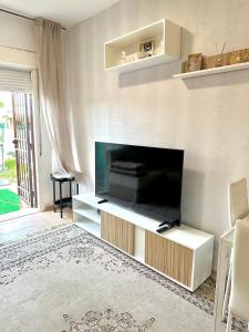 a living room with a large flat screen tv at Casa rural con jardín y piscina in Val de Santo Domingo