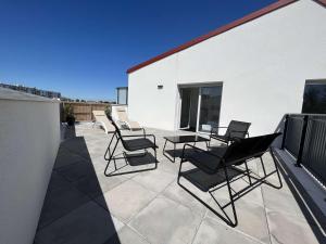 a group of chairs and a table on a patio at Appartement La Rochelle, 4 pièces, 8 personnes - FR-1-246-698 in La Rochelle