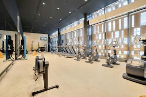 a gym with rows of exercise bikes and machines at Sub-penthouse Stunning With Water Frontage 3B2B1C in Melbourne