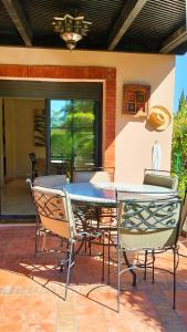 een eettafel en stoelen op een patio bij La Perle de l'Atlas by Golf Resort in Marrakesh