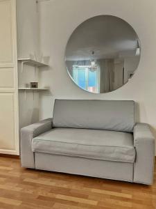 a couch in a living room with a mirror at City Center Residence - 64 m2 St Eriksplan in Stockholm