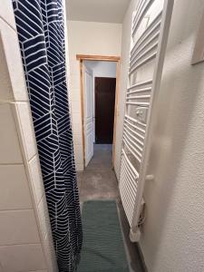 a hallway with a heater and a door to a room at T2 centre Ville Proche des pistes in Briançon