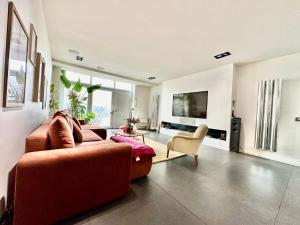 a living room with a couch and a chair at Luxurious Loft - Alfortville in Alfortville