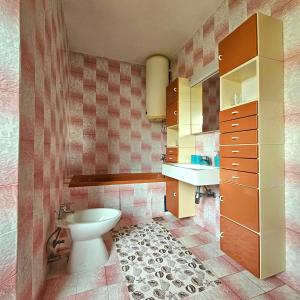 a bathroom with a toilet and a sink at Apartman Agava in Njivice
