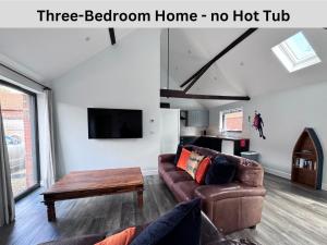a living room with a three bedroom home no hot tub at Brick Kiln Barns in North Walsham