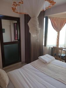 Postel nebo postele na pokoji v ubytování Paleo Hotel and Spa, Thika