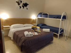 a bedroom with two bunk beds and a table at Valle Dei Templi Rent BedRooms in Agrigento