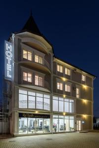 a building with a sign in front of it at Sagora Hotel in Chernivtsi