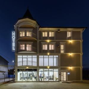 a building with a store front at night at Sagora Hotel in Chernivtsi