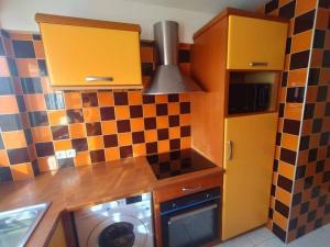 a kitchen with a stove top oven next to a washer at 5 mins to metro La defense, 2 bedrooms and 1 salon in Puteaux