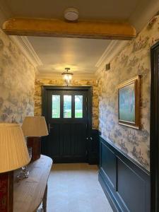 a room with a door and a table with two lamps at Home Farm Cottage in Lytham St Annes