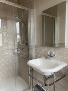 a bathroom with a sink and a shower at Home Farm Cottage in Lytham St Annes +23 photos
