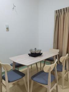 a white table with chairs and a bowl on it at KSL Bungalow JBCC MidValley Mini Theater Pool CIQ in Johor Bahru +12 photos